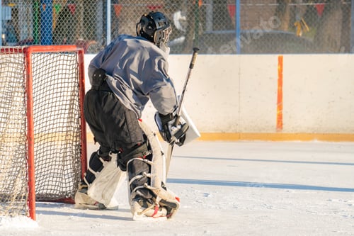 Preview: close up alone hockey goalkeeper protecting the gates during the match on the ice f