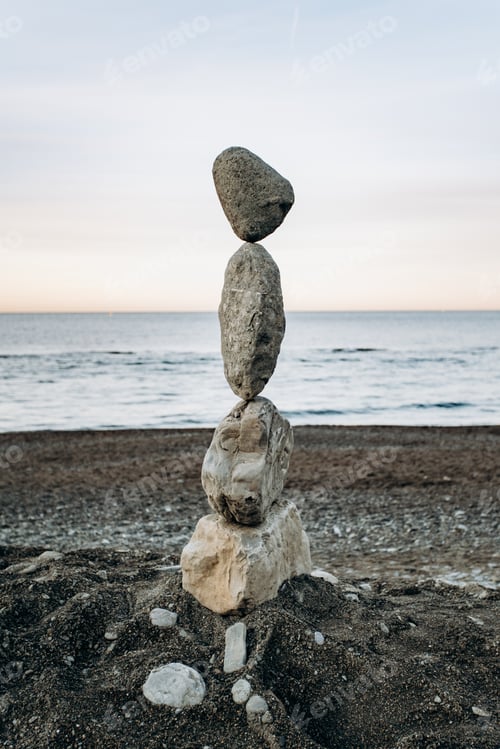 Preview: The figure of stones standing on each other, on the beach against the sea.