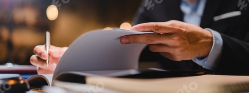 Preview: businessman or legal expert reviewing document reports at office workplace with computer laptop