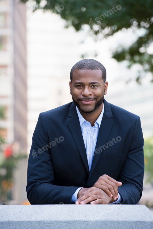 Preview: Business man in a blue jacket and open necked shirt.