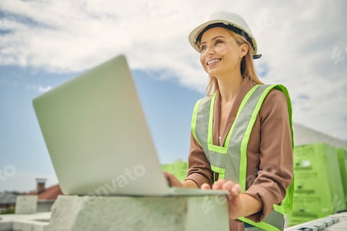 Preview: Female constructor sitting at a building site