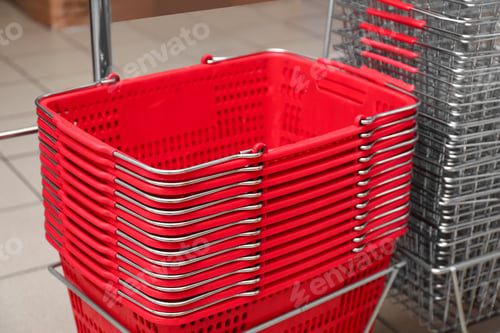 Preview: Stack of empty shopping baskets in supermarket, closeup