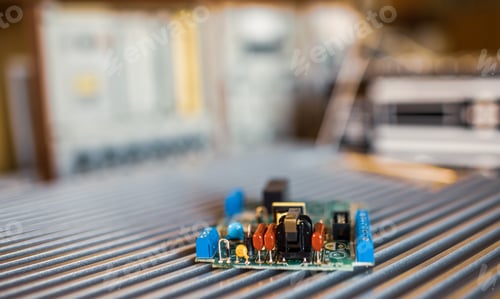 Preview: Close-up electric green embedded microcircuits in production