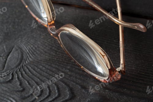 Preview: eyeglasses on wooden table