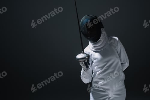 Preview: Swordswoman in fencing suit and mask holding rapier isolated on black