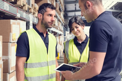 Preview: Warehouse workers using digital tablet in distribution warehouse