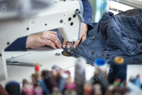 Preview: Closeup shot of a person using a sewing machine