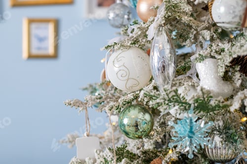 Preview: Christmas tree with blue and silver toys. Festively decorated Christmas tree with garlands. Symbol