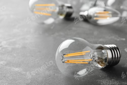 Preview: Vintage lamp bulb on grey background. Space for text
