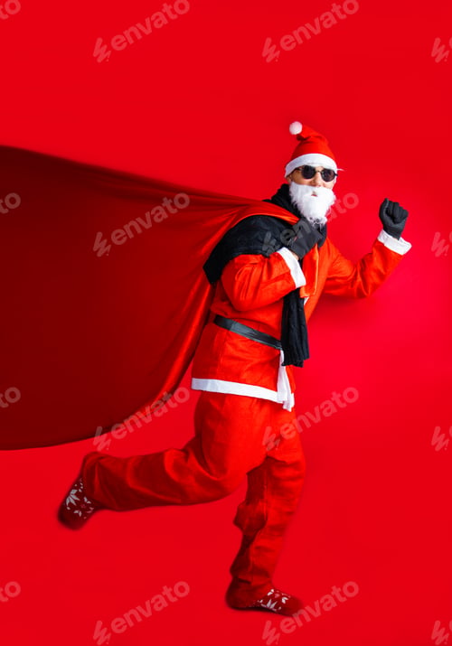 Preview: funny excited man pensioner dressed santa claus costume carrying big christmas sack