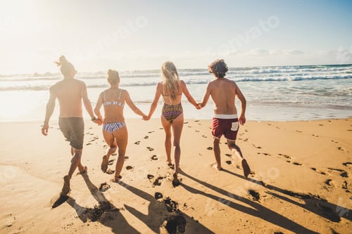 Preview: Group of young people friend have fun at the beach in summer holiday vacation running