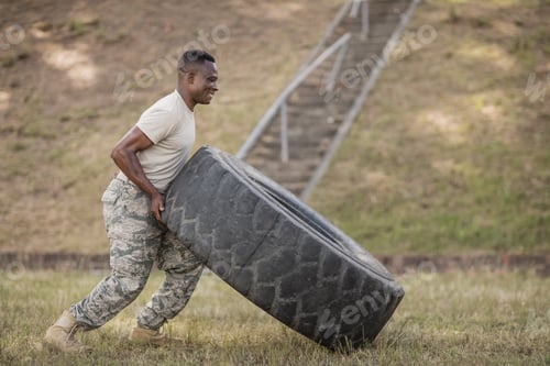 Preview: Determined military soldiers exercising with tyre