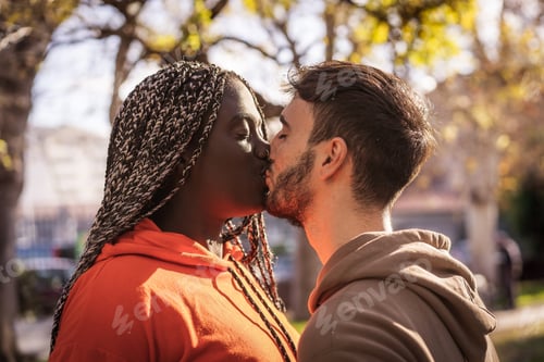 Preview: Biracial couple kissing outdoors