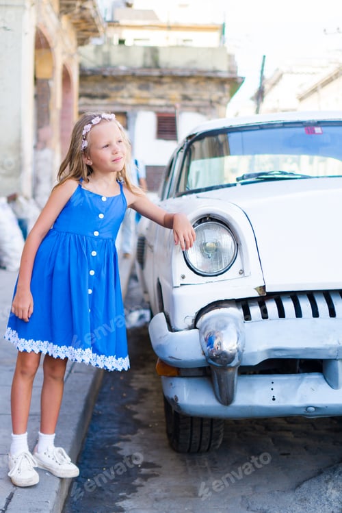 Preview: Adorable little girl in popular area in Old Havana, Cuba. Portrait of kid background vintage classic