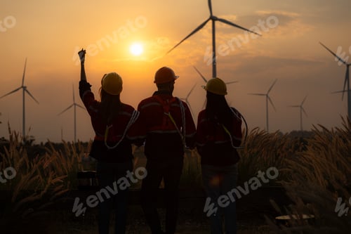 Preview: Silhouette of group engineers and windmills on the background of the setting sun