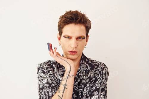 Preview: Young gay man is standing in the studio and posing for a camera