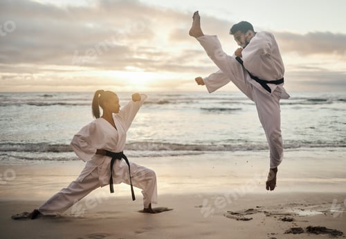 Preview: Karate all day. Shot of two young martial artists practicing karate on the beach.