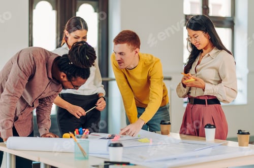 Preview: Redhead businessman holding a meeting in an office with other diverse architects