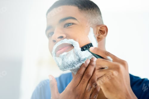 Preview: Woke up in the mood to shave this morning. Shot of young man focusing as he shaves his face.