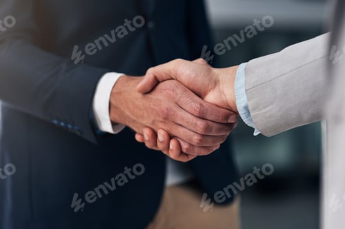 Preview: It all boils down to trust. Cropped shot of two businessmen shaking hands in a modern office.