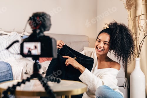 Fashion vlogger reviewing and marketing black jeans