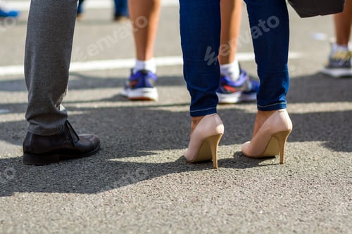 Preview: Close up of men and women legs in different shoes, high heels walking fast