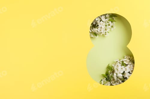Preview: 8 March greeting card. Paper cut Eight made of yellow background and fresh spring flowers bouquet of