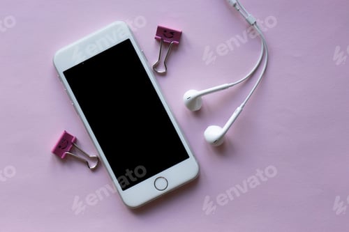 Preview: A mobile phone and earphones lying on a table