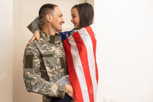 Preview: a child girl hugs a military father. dad in military uniform with his daughter. the veteran's return
