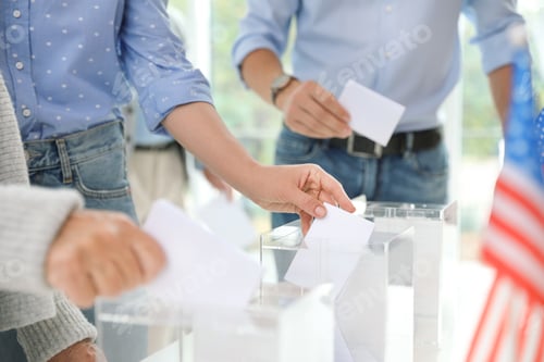Preview: People putting ballot papers into boxes at polling station, closeup