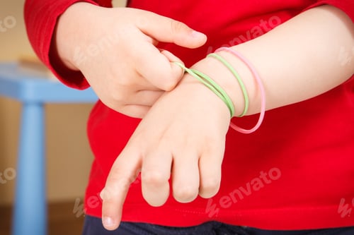 Preview: Preschooler playing with rubber erasers. Development of kids motor skills