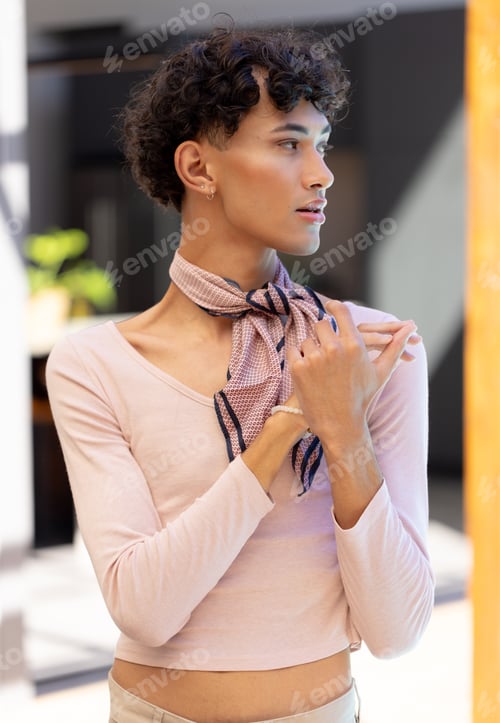 Preview: Posing confidently, transgender transgender woman wearing stylish scarf and light pink top