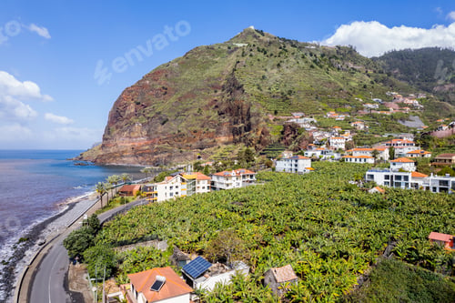 Preview: Aerial view of small farming village with banana plantation at Madeira Atlantic Ocean coast