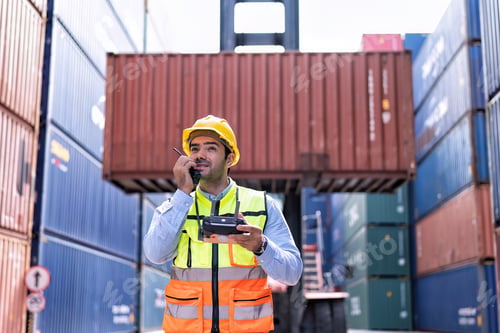 Preview: Engineer working in container storage yard fly drone looking location layout prepare to delivery