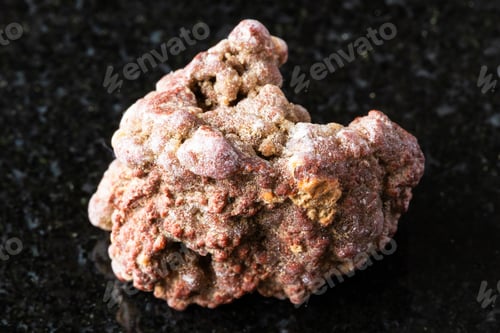 Preview: sample of raw chalcedony mineral on black granite