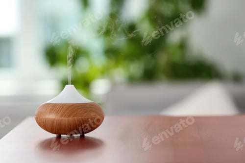 Preview: Aroma oil diffuser lamp on table against blurred background