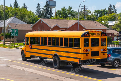 Preview: Yellow school bus driving on suburban street during the daytime