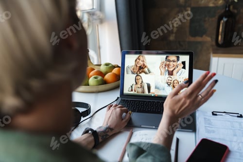 Preview: Back view of a smiling mid aged blonde woman