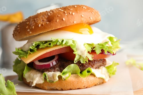 Preview: Tasty burger with fried egg on wooden board