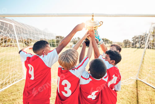 Preview: Children, winner and team soccer with trophy celebrating victory, achievement or match on the field