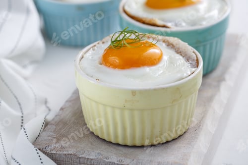 Preview: Baked eggs in ramekins close view, selective focus