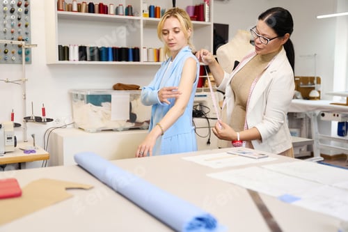 Preview: Customer is being fitted by experienced craftswoman in sewing studio