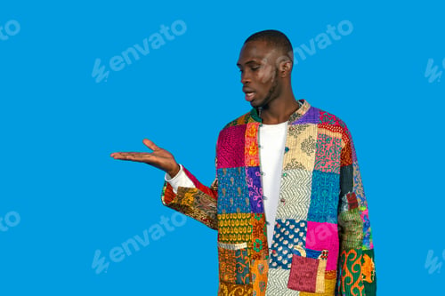 Preview: Black man presenting empty hand on blue background