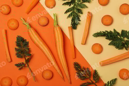 Preview: Slices and leaves of fresh carrot on two tone background