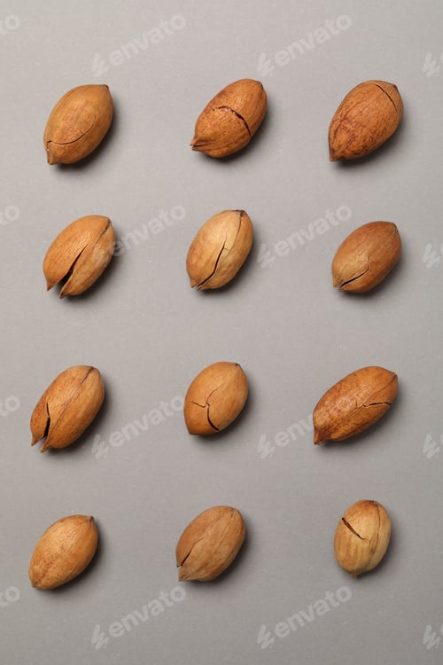 Preview: Flat lay with tasty pecan nuts on gray background