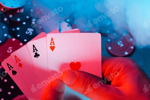 Preview: men's hands hold aces cards against the background of playing chips. the photo shows smoke