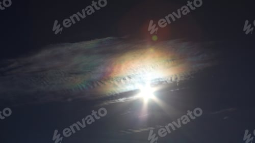 Preview: Brilliantly Colored Iridescent Clouds In A Blue Sunny Sky - Photograph Of A Bright Sun Surrounded