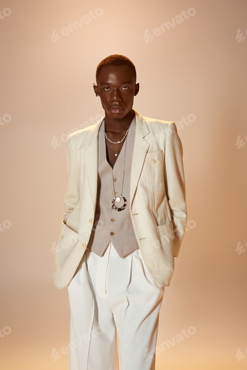 Preview: Stylish young man exudes confidence in a vibrant outfit during a photoshoot in a studio setting