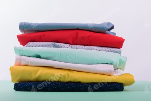 Preview: Stack of bright female trousers.