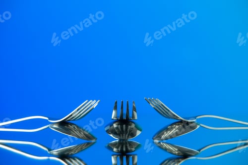 Preview: front view metal forks on blue background cutlery kitchen food color photo table restaurant